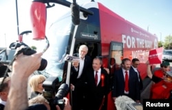 Jeremy Corbyn, the leader of Britain's opposition Labour Party, boards his battle bus as he campaigns in Whythenshawe, May 9, 2017.