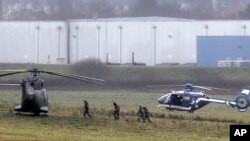 La police et les forces de l'armée prennent des positions à Dammartin-en-Goële, au nord-est de Paris, dans le cadre d'une opération de saisir deux suspects lourdement armés, le vendredi 9 janvier 2015.