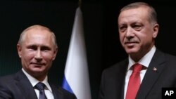 FILE - Russian President Vladimir Putin, left, and his Turkish counterpart, Recep Tayyip Erdogan, wrap up a joint news conference at the Presidential Palace in Ankara, Turkey, Dec. 1, 2014, when they enjoyed more cordial relations. 