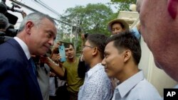 Two Reuters journalists Kyaw Soe Oo, right, and Wa Lone, center, are welcomed by Reuters officials as they were released from Insein Prison in Yangon, Myanmar, May 7, 2019.