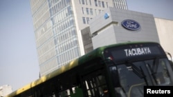 A bus passes in front of a Ford logo near a sales store of the automaker in Mexico City, Mexico, April 5, 2016.
