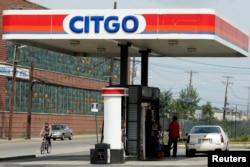 FILE - A driver fuels up at a Citgo gas station in Kearny, New Jersey, Sept. 24, 2014. The U.S. Chamber of Commerce has proposed an increase in the federal gas tax to shore up the Highway Trust Fund.
