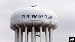 FILE - The Flint, Michigan, water tower is seen in a Feb. 5, 2016, photo. Flint is under a public health emergency after its drinking water became tainted when the city switched from the Detroit system and began drawing from the Flint River in 2014 to save money.