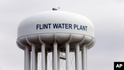 The Flint, Mich.,water tower is seen in this Feb. 5, 2016 photo. Flint is under a public health emergency after its drinking water became tainted when the city switched from the Detroit system and began drawing from the Flint River in 2014 to save money.