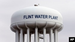 FILE - The Flint, Michigan, water tower is seen in a Feb. 5, 2016, photo. Flint is under a public health emergency after its drinking water became tainted when the city switched from the Detroit system and began drawing from the Flint River in 2014 to save money.