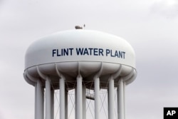 The Flint, Mich.,water tower is seen in this Feb. 5, 2016 photo. Flint is under a public health emergency after its drinking water became tainted when the city switched from the Detroit system and began drawing from the Flint River in 2014 to save money.