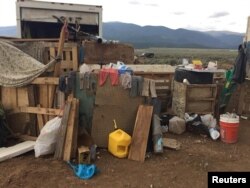 Conditions at a compound in rural New Mexico where 11 children were taken into protective custody for their own health and safety after a raid by authorities, are shown in this photo near Amalia, New Mexico, provided Aug. 6, 2018.