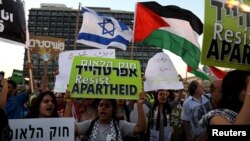 FILE - Israeli Arabs and their supporters take part in a rally to protest against Jewish nation-state law in Rabin square in Tel Aviv, Israel, Aug. 11, 2018.