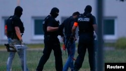 Twenty-year-old Iraqi Ali B. is escorted by special police upon his arrival in Wiesbaden, Germany, June 9, 2018.