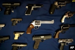 FILE - Guns seized by the police are displayed during a news conference in New York.