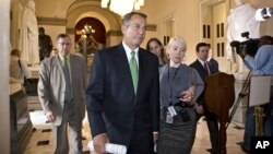 House Speaker John Boehner of Ohio is pursued by reporters as he walks to the House floor to deliver remarks about negotiations with President Barack Obama on the fiscal cliff, Tuesday, Dec. 11, 2012, on Capitol Hill in Washington.