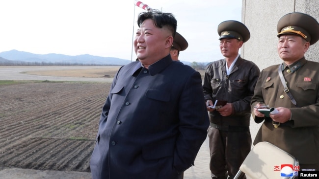 FILE - North Korean leader Kim Jong Un, accompanied by two military officials, observes a Korean People's Air Force training flight at undisclosed location in this April 16, 2019, photo released April 17, 2019, by North Korea's Central News Agency (KCNA).