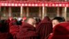 About 90 monks sit in front of a red banner that says: "Work Meeting for the Second Phase of Xicang Monastery's Rule of Law Propaganda Education Campaign," ahead of the re-education study session at the 200 year old Xicang Monastery in Luqu, China, Nov. 23, 2008.