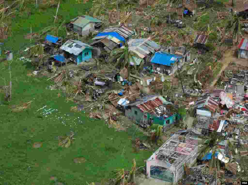 A devastated village in Eastern Samar province makes a plea for help, Philippines, Nov. 19, 2013. (Steve Herman/VOA) 