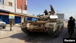 Troops from eastern Libyan forces are seen in Ain Zara, south of Tripoli, Libya, April 11, 2019. 