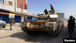 FILE - Troops from eastern Libyan forces are seen in Ain Zara, south of Tripoli, Libya, April 11, 2019. 