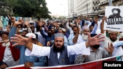 Supporters of the banned Islamist political party Tehreek-e-Labbaik Pakistan chant slogans demanding the release of their leader and the expulsion of the French ambassador over cartoons depicting the Prophet Mohammed, during a protest in Karachi, Pakistan, Oct. 29, 2021. 