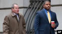 FILE - William Porter, right, one of six Baltimore city police officers charged in connection to the death of Freddie Gray, walks into a courthouse with his attorney Joseph Murtha on Nov. 30, 2015, in Baltimore.
