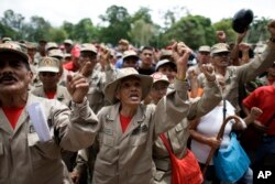 Militia members shout slogans during a speech by the commander of the Venezuelan Bolivarian Militia, Gen. Carlos Leal Telleria, in Fort Tiuna, Caracas, Venezuela, Aug. 25, 2017. President Nicolas Maduro ordered military exercises in response to President Donald Trump's warning of possible military action to resolve the country's crisis.