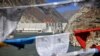 Prayer flags hang before Zangmu Hydropower Station in Gyaca county in Lhoka, or Shannan prefecture, southwest China's Tibetan Autonomous Region, Nov., 23, 2014.