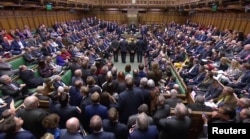 Tellers announce the results of the vote on Brexit in Parliament in London, Britain, March 13, 2019, in this image taken from video.