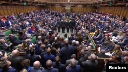 Tellers announce the results of the vote on Brexit in Parliament in London, Britain, March 13, 2019, in this image taken from video. 