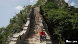 A man rests while working on the reconstruction of the Jiankou section of the Great Wall, located in Huairou District, north of Beijing, China, June 7, 2017. 