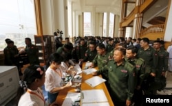 Military members of parliament arrive at the Union Parliament in Naypyitaw, Myanmar, March 15, 2016.