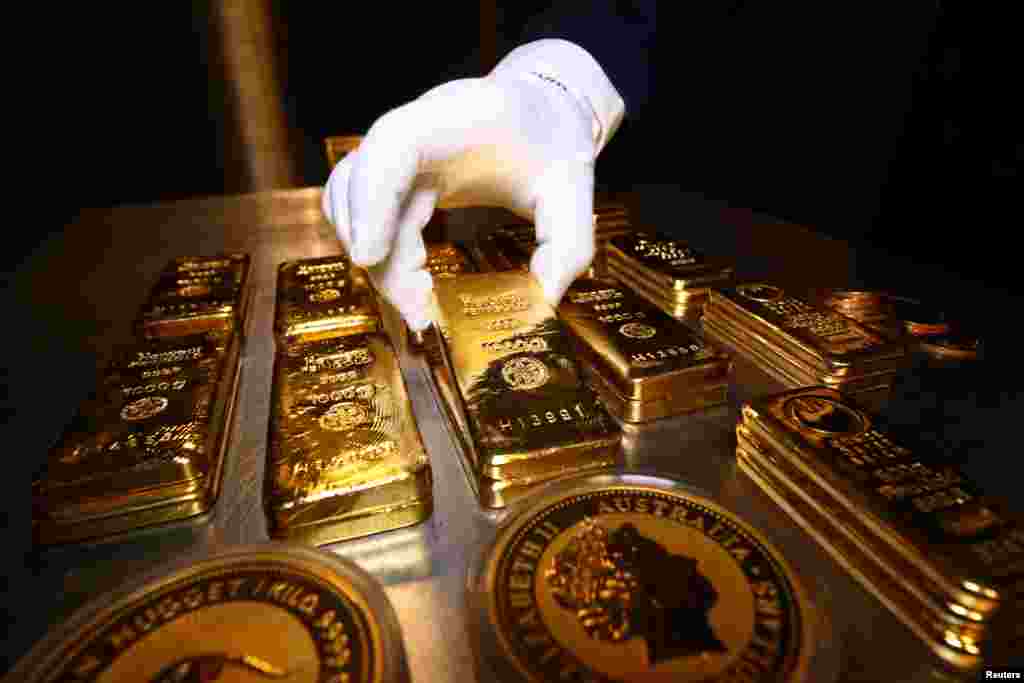 Gold bars and coins are stacked in the safe deposit boxes room of the Pro Aurum gold house in Munich, Germany.
