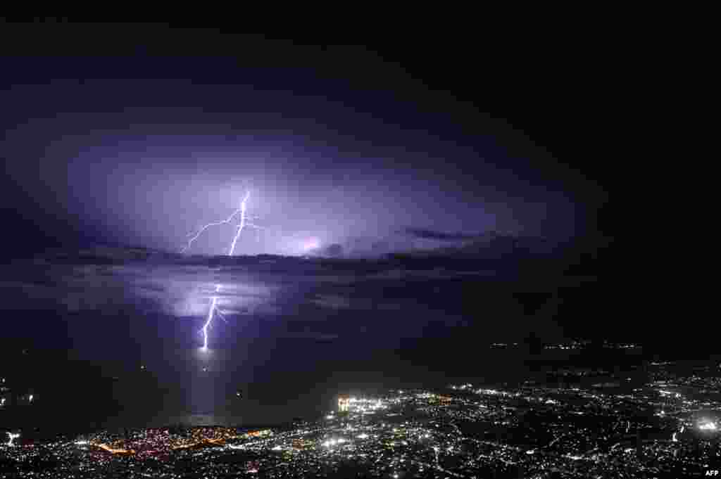 Lightning strikes over the sea along the coast of the Haitian capital, Port au Prince, Sept. 24, 2014.