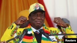 President Emmerson Mnangagwa greets supporters of his ruling ZANU PF party gather for an election rally in Chinhoyi, Zimbabwe, July 17, 2018. 