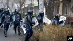 Riot police walk to block demonstrators during a protest in Almaty, Kazakhstan, Jan. 5, 2022. 