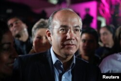 FILE - Former Mexican president Felipe Calderon attends an event where his wife Margarita Zavala, presidential independent pre-candidate, thanks her campaign staff for helping her to collect citizen's signatures for the electoral authority to become an independent candidate, in Mexico City, Mexico Feb. 19, 2018.
