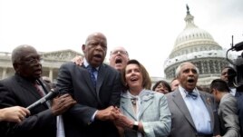 From left, House Assistant Minority Leader James Clyburn, Rep. John Lewis, D-Ga., Rep. Joseph Crowley, D-N.Y., House Minority Leader Nancy Pelosi of California, and Rep. Charles Rangel, D-N.Y., sing 