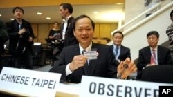 FILE - Taiwan's health minister Ching-Chuan Yeh shows his badge at the World Health Assembly in Geneva, Switzerland, May 18, 2009.