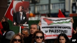 Protesters, holding Turkish and Palestinian flags and a placard of Mustafa Kemal Ataturk, the founder of modern Turkey, chant anti-U.S. slogans during a rally in Istanbul, Saturday, Dec. 9, 2017 against U.S. President Donald Trump's decision to recognise Jerusalem at the capital of Israel.