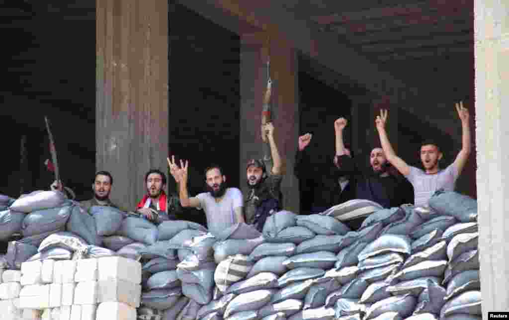 Soldiers loyal to President Bashar al-Assad pose for a photo in Aleppo&#39;s main prison, May 22, 2014.