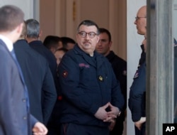 Chaplain of the Paris Fire Department, Jean-Marc Fournier, center, waits at the Elysee Palace in Paris prior to a meeting with French President Emmanuel Macron, April 18, 2019.