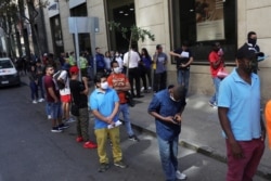 CHILE -- Workers wait in line to apply for unemployment insurance outside the offices of the Unemployment Fund Administrator during a preventive quarantine, after the outbreak of coronavirus disease (COVID-19) in Santiago, Chile, April 2, 2020.