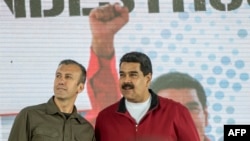 FILE - Venezuelan President Nicolas Maduro (R) and his Vice President Tareck El Aissami participate in a rally with workers of PDVSA state-owned oil company in Caracas.