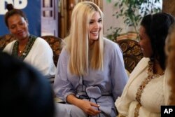 White House senior adviser Ivanka Trump smiles at Azalech Tesfaye, right, who is the recipient of loan guarantee through USAID, as Trump meets women who work in the Ethiopian coffee industry, April 14, 2019, in Addis Ababa.