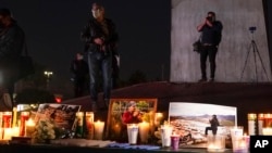 FILE - Journalists cover a vigil in honor of news photographer Margarito Martinez, Jan. 21, 2022, in Tijuana, Mexico. Martinez, a Tijuana-based photojournalist who specialized in covering crime scenes in this border city, was shot as he left his home four days earlier. 