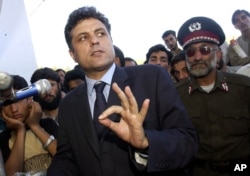 FILE - Then-Presidential candidate Abdul Latif Pedram gestures as he speaks to supporters during a campaign stop at a stadium of western city in Herat, Afghanistan, Oct. 3, 2004.