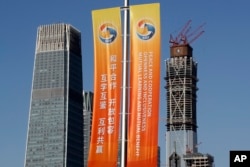 Banners promoting the Belt and Road Forum for International Cooperation are placed between skyscrapers in the central business district in Beijing, May 11, 2017.