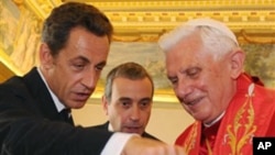French President Nicolas Sarkozy exchanges gifts with Pope Benedict XVI during a private audience at the Vatican, Friday, Oct. 8, 2010.