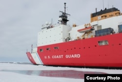 FILE - Coast Guard icebreaker Cutter Healy perches next to a shallow melt pond on the ice in the Chukchi Sea, north of the Arctic Circle, July 20, 2016.