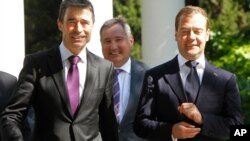 Russian President Dmitry Medvedev (R), Russia's ambassador to NATO Dmitry Rogozin (C) and NATO Secretary General Anders Fogh Rasmussen walk together during their meeting in the southern Russian city of Sochi. NATO's chief defended the alliance's Libya ope