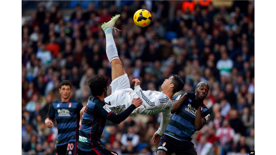 FILE - Real Madrid's Cristiano Ronaldo, of Portugal, top, tries to score in between opposition players during a Spanish La Liga soccer match between Real Madrid and Granada at the Santiago Bernabeu stadium in Madrid, Spain, Jan. 25, 2014.