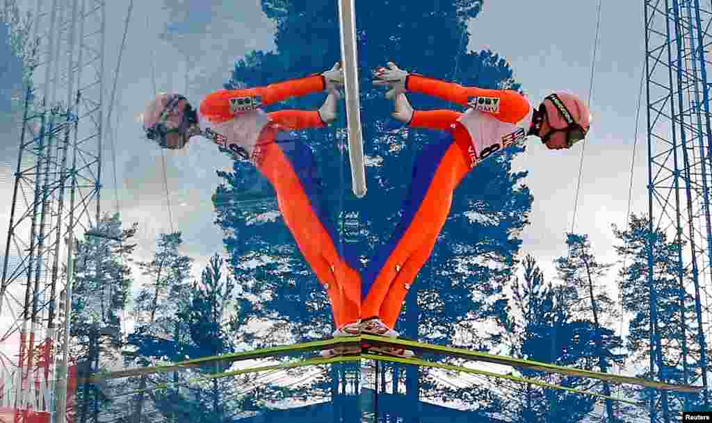 Stefan Kraft of Austria is mirrored during his jump in a training session of the men&#39;s normal hill individual HS100 ski jumping at the Nordic World Ski Championships in Falun, Sweden.