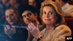 French actress Catherine Deneuve, president of the Premiers Plans film festival, applauds during the festival's opening session in Angers, western France, Jan. 15, 2018, . 